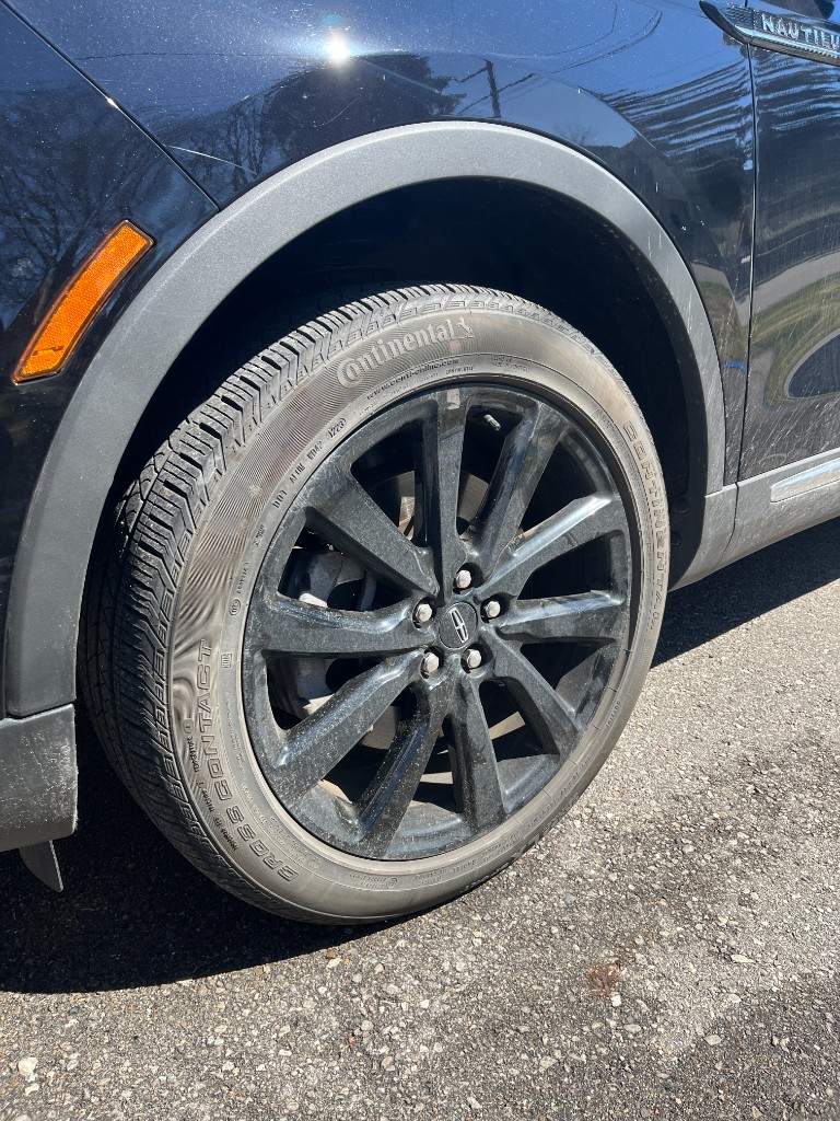 Dirty car wheel before detailing